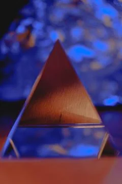Prismatic pyramid reflecting light in a creative abstract setting Stock Photos