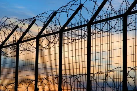 Prison barbed wire, at sunset, depression 写真素材