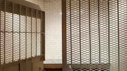 Prison with bars and open cell door Stock Photos