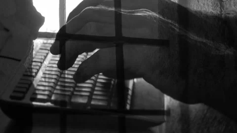 Prison bars are placed on the hands of a programmer typing a code on a comput Video stock 155977116