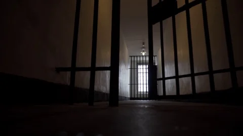 Prison Bars Close in a Dark, Depressing and Lonely Looking Jail Cell in 4K Stock Footage