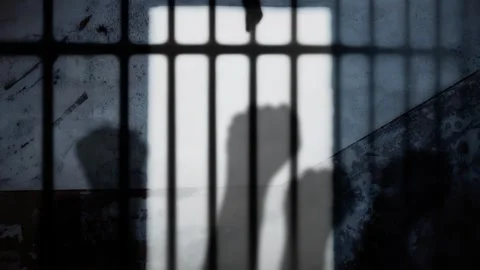 Prison bars raising fists Stock Footage 277770489
