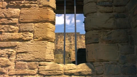 Prison bars on a stone wall Vidéo 338024024