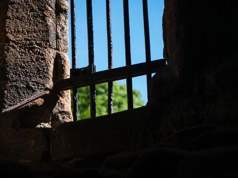 Prison bars on a stone wall Stock Photos