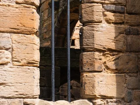 Prison bars on a stone wall Stock Photos