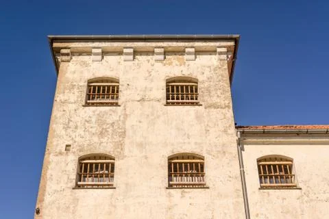 Prison building with bars on windows Stock Photos