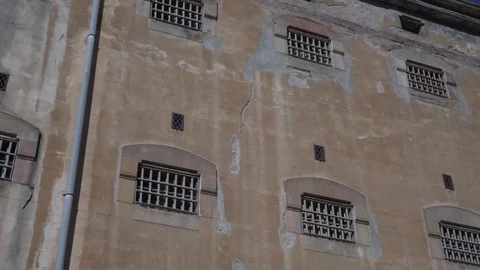 Prison building wall with bars on the windows. 스톡 동영상 123671803