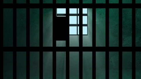 A prison cell with bars and rays of light coming through the window. 4K 動画素材 343646277