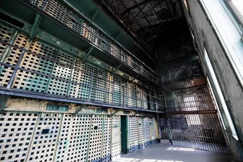 A prison cell block with bars on the windows Stock Photos