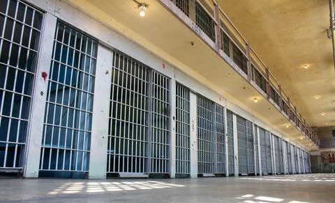 A prison cell block with many cells and bars Foto stock