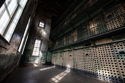 A prison cell block with a window in the middle Stock Photos
