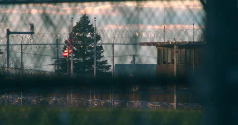 Prison, correctional facility exterior. Pan through fencing. Stock Footage 143759913