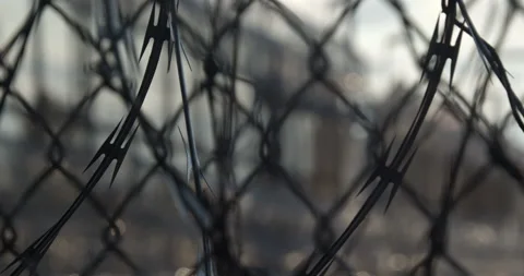 Prison, correctional facility. Pull focus on Razor wire fence. Stock Footage 143760844