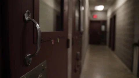 Prison facility hallway with prison cell doors. Video stock 254401673
