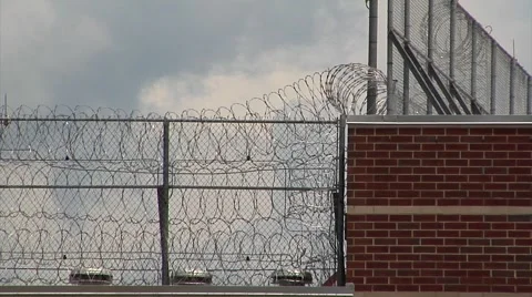 Prison, Federal, razor wire on roof Stock Footage