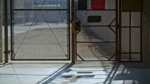 Prison gate automatically opening to the yard Stock Footage 331601932