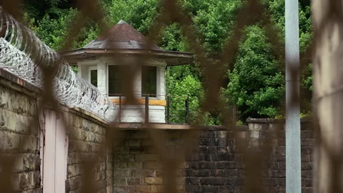 Prison Guard Tower with Razor Wire on Jail Wall Stock Footage 133558952
