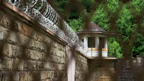 Prison Guard Tower with Razor Wire on Jail Wall Видео 133559904