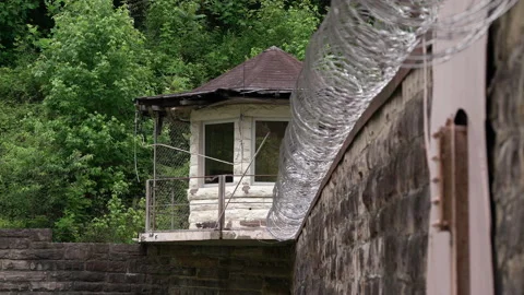 Prison Guard Tower with Razor Wire on Jail Wall Stock Footage 133563851
