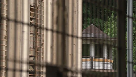 Prison Guard Tower with Razor Wire on Jail Wall Stock Footage 133566048