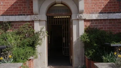 Prison guard walking in to prison Stock Footage 82460884