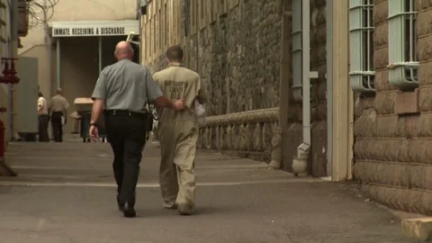 Prison Guard Walks Inmate Inside the Jailhouse Stock Footage