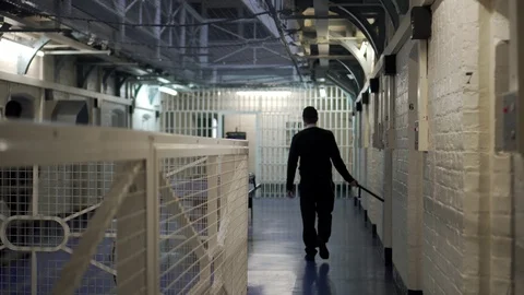 Prison Guard Walks Through Wing Block With Baton, Modern Incarceration 4K Stock Footage