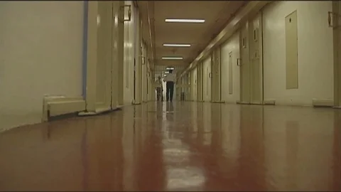 Prison Guards at End of Long Prison Hallway Stock Footage 101624405