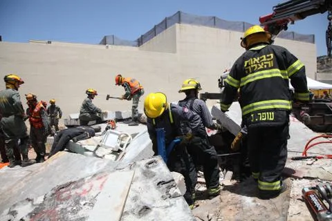 Prison guards rescue rocket attack casualties in Carmel Prison, Israel, durin Stock Photos