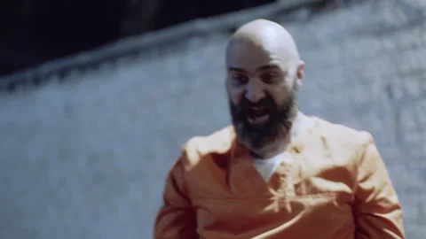 Prison inmate laughing while playing basketball Stock Footage 283083031