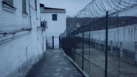 Prison Jail Yard and Barbed Wire Stockbeeldmateriaal 283084923