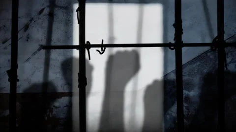Prison light raising fists Stock Footage 264342617