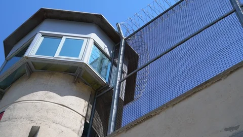 Prison observation tower and high barbed wire fence, bottom view. Stock Footage 115156975
