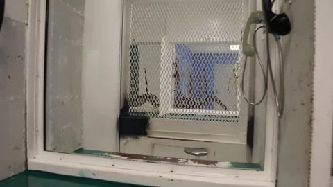 Prison phone booth in jail where prisoners can speak to family members Stock Footage 247297775