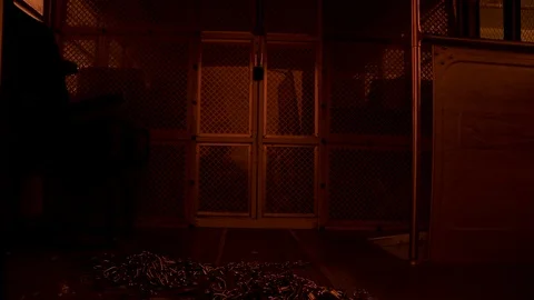 Prison storage closet with pile of chains and handcuffs on floor. 스톡 동영상 106533358