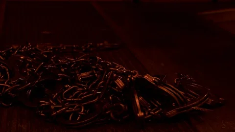 Prison storage closet with pile of chains and handcuffs on floor. Video stock 106538440
