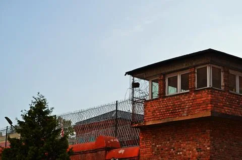Prison tower and barbed wire fence Stock Photos