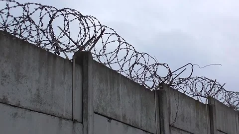 Prison Wall with barbed Wire Stock Footage 142587897