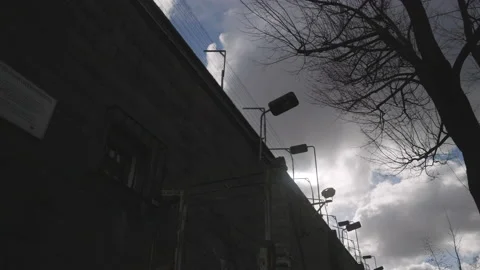 Prison Wall Exterior Barb Wire Fence - Stasi Jail Hohenschönhausen Timelapse 8k Stock Footage 234064979