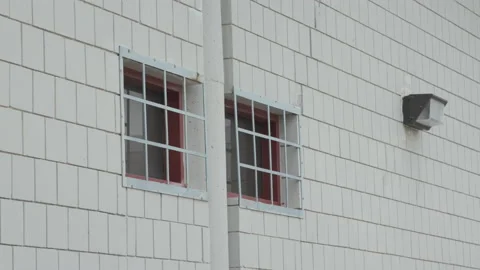 Prison Windows with Bars Over the Glass Stock Footage 154414481