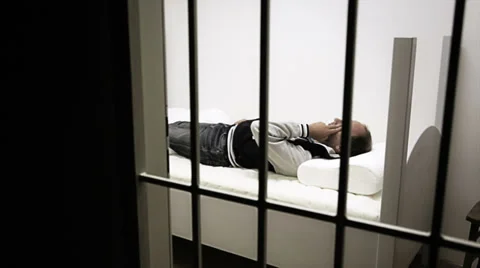 Prisoner asleep in his cell Stockbeeldmateriaal 32499604