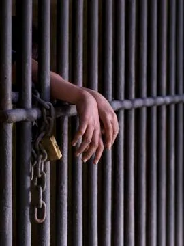 Prisoner with both hand outside the prison Stock Photos