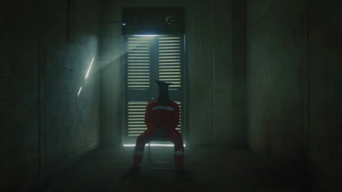 Prisoner in chains waiting to be interrogated Stock Footage 275039138