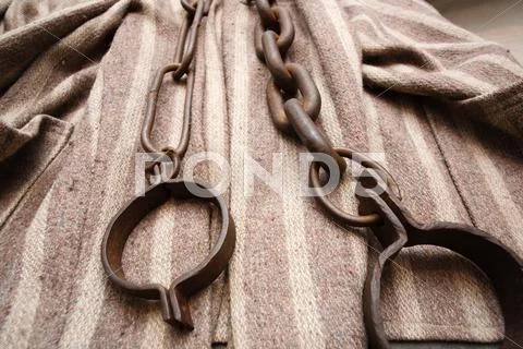 Prisoner clothes and chains Stock Photos