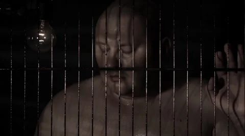 Prisoner in jail cell Stock Footage 8607011