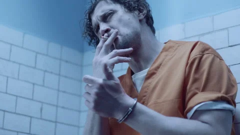 A prisoner lighting a cigarette Stock Footage 283080270