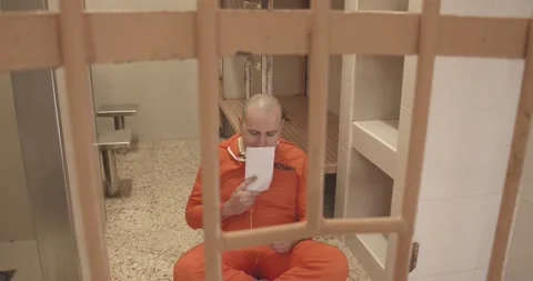 Prisoner opens an envelope with a letter Stock Footage 171089906