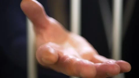 Prisoner outstretched hand from behind prison bars Stock Footage 153215292