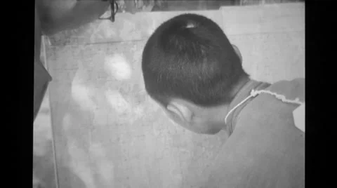 Prisoner pointing out enemy positions on a map placed against a tree Stock Footage 36423906