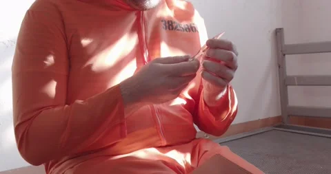 Prisoner pulls out a handmade weapon from the book. Video stock 168909148